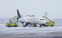 During winter, precipitation in freezing conditions causes ice to accumulate on the leading edge of wings, tailplanes, and vertical stabilizers of airplanes.
