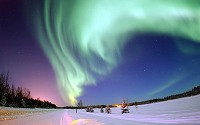 Aurora Borealis or Northern Lights, shines above Bear Lake on Eielson Air Force Base, Alaska on 18 January 2005.