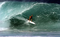 Surfing along the face of a breaking ocean wave is an exciting adventure sport.