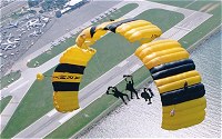 Three members of the US Army Parachute team Golden Knights parachuting down towards Cleveland International Airshow.