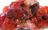 Minerals, such as Garnet (pictured here), are naturally occurring substances formed through geological processes.